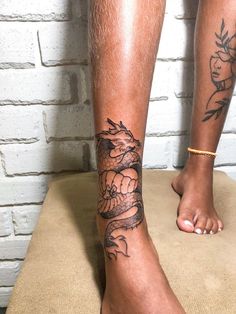 two people with tattoos on their legs and feet