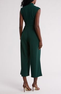 A contrasting buckle defines the waist of this woven jumpsuit that's cut right at your ankle for trend-right charm. 25 1/2" inseam Hidden back-zip closure Mock neck
 Cap sleeves Side-seam pockets Removable waist tie 66% polyester, 30% recycled polyester, 4% spandex Dry clean Imported Fitted Calvin Klein Jumpsuits And Rompers For Party, Workwear Jumpsuits And Rompers With Belt Loops, Chic Belted Green Jumpsuits And Rompers, Chic Green Belted Jumpsuits And Rompers, Chic Green Belted Jumpsuit, Fitted Belted Strapless Jumpsuit, Belted Strapless Jumpsuit For Workwear, Chic Belted Strapless Jumpsuit For Work, Fitted Sleeveless Jumpsuit With Belt Loops