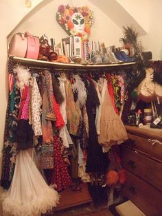 a closet filled with lots of clothes and accessories