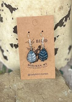 Add a touch of nature, whimsy, and craftsmanship to your jewelry collection with our blue etched glass leaf design earrings. These exquisite beads are meticulously crafted in the Czech Republic, known for its centuries-old glassmaking tradition. Each bead features intricate etching that creates a textured, frosted look, adding depth and character to your pendant earrings. Ideal for pendant earrings, these lightweight beads are easy to work with, offering a refined, vintage-inspired aesthetic tha Blue Leaf-shaped Jewelry Gift, Blue Leaf-shaped Jewelry For Gift, Nature-inspired Blue Dangle Earrings, Blue Nature-inspired Drop Earrings, Handmade Blue Leaf-shaped Jewelry, Etched Blue Jewelry For Gift, Unique Blue Etched Jewelry, Unique Etched Blue Jewelry, Leaf Design Earrings