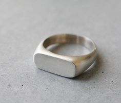 Unisex sterling silver signet ring, designed with a center rectangular outline, perfect for a unique wedding ring. * Can also be made in 18k gold - please contact me for details. * Finish- Matte or Shiny. * Can be made in yellow, white or rose 14k gold. * This price is for a ring in a size up to 9, if you need a bigger size > contact me for price & details. * All jewelry will be sent in a beautiful gift box. * Handmade in my villages studio in northern Israel within 2-3 weeks. * FREE ship Signet Engagement Rings, Signet Ring Women, Signet Ring Silver, Mens Signet Ring, Minimalist Wedding Rings, Tiny Gold Studs, Diamond Nose Ring, Gift Box Handmade, 14k Gold Wedding Ring