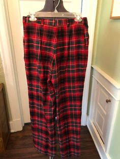 "These are classic red plaid pants. These pants are made of 100% wool fabric in a red, black, royal blue, forest green and yellow plaid.  They are lined.  They features a waistband with belt loops, side pockets and front zipper/hook and eye closure. This garment is clean, with no stains, or snags.  There is one small moth hole on the lower left inside leg. Measurements for you: Waist: 30\" Hip: 40\" Inseam: 30.5\" Front Rise: 13\" Decade: 80s Fabric: Wool Size: M Condition: Great Brand: Cross Co Plaid Tapered Leg Pants For Fall, Classic Plaid Cotton Bottoms, Plaid Full-length Pants For Fall, Plaid Full Length Pants For Fall, Classic Plaid Pants For Fall, Plaid Winter Trousers, Classic Red Bottoms For Winter, Classic Red Winter Bottoms, Classic Plaid Bottoms For Winter