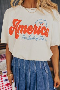 – Light up the skies this summer in our casual but cute tee – Lightweight cotton material with a red and blue patriotic graphic design – Round neckline – Short loose sleeves – Slouched silhouette that falls into a straight unfinished hemline American Retro Cotton Relaxed Fit Top, Spring Americana T-shirt With Graphic Print, American Retro Cotton Tops With Relaxed Fit, Spring Americana Graphic Print T-shirt, Spring Americana Style Graphic Print T-shirt, American Retro Relaxed Fit Cotton Top, American Retro Cotton Top With Relaxed Fit, American Style Short Sleeve T-shirt For Spring, Short Sleeve T-shirt For Spring