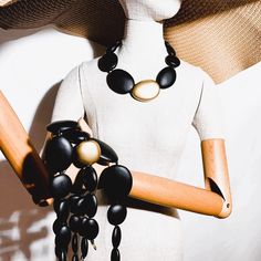 Multistrand bold necklace. Four strands of matte black and gold beads Multi-strand Gold Jewelry With Wooden Beads, Gold Multi-strand Jewelry With Wooden Beads, Black Double Strand Necklace With Beads, Black Double Strand Necklace With Black Beads, Elegant Long Beaded Necklace With Wooden Beads, Elegant Long Wooden Beaded Necklace, Elegant Multi-strand Necklaces With Wooden Beads, Elegant Multi-strand Necklace With Wooden Beads, Adjustable Double Strand Black Beaded Necklace