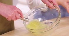 two people are mixing together food in a bowl