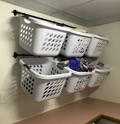 several laundry baskets are hanging on the wall