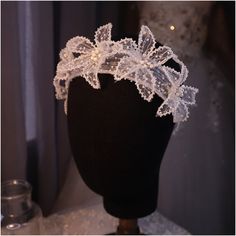 a white headpiece on a black mannequin