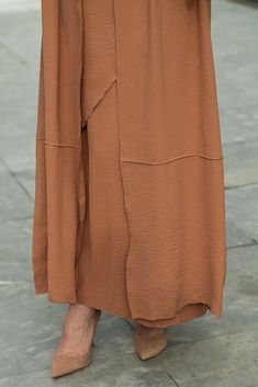 Introducing the Deluna three piece maxi lightweight abaya in rustic brown. This elegant and versatile design is perfect for any season and includes a long sleeve slip dress, apron piece, and a throw over abaya. The fabric is specially designed to resist wrinkles and the contrast brown color overlook seam at the edge of the abaya stands out.The abaya is super lightweight and flowy making it perfect for hot weather. The apron piece allows you to adjust the fit and the pattern of the abaya is not o Fall Season Modest Maxi Length Abaya, Modest Maxi Length Abaya For Fall, Fall Modest Maxi Length Abaya, Elegant Brown Full-length Maxi Skirt, Elegant Brown Full Length Maxi Skirt, Spring Modest Maxi-length Thobe, Brown Full-length Maxi Skirt For Fall, Brown Full Length Maxi Skirt For Fall, Fall Full Length Brown Maxi Skirt