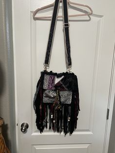 Black/gray/lavender hippie/boho bag/purse with embroidered adjustable guitar strap. Handmade Purple Bags For Festival, Hippie Handmade Festival Shoulder Bag, Hippie Handmade Shoulder Bag For Festival, Handmade Hippie Shoulder Bag For Festival, Black Bohemian Hobo Bag, Bohemian Hobo Bag With Detachable Strap, Bohemian Crossbody Satchel With Fringe, Bohemian Hobo Bag With Detachable Strap For Travel, Black Bohemian Satchel Bag