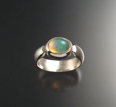 Opal Ring made to order in your size | Etsy Modern Oval Cabochon Opal Ring, Modern Green Round Dome Ring, Green Oval Opal Ring With Bezel Setting, Modern Oval Opal Ring With Bezel Setting, Green Domed Jewelry With Polished Finish, Modern Opal Ring With Bezel Setting, Modern Iridescent Round Ring, Modern Iridescent Round Rings, Blue Crystal Ring