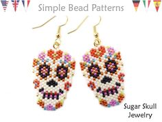 a pair of beaded sugar skull earrings with colorful beads on the front and back