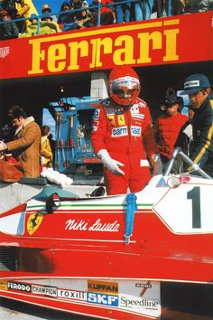 a man standing in front of a race car