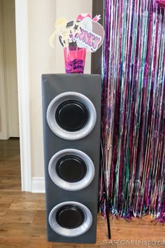 two speakers sitting next to each other in front of a party streamer and confetti