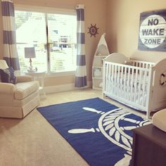 a baby's room with blue and white decor