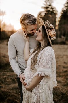 a man and woman standing next to each other in a field