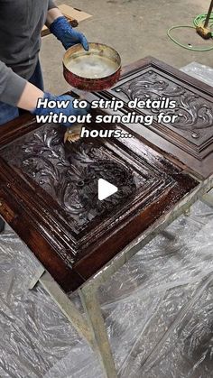 a woman is sanding down a wooden table