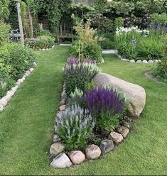 a garden with rocks and flowers in it