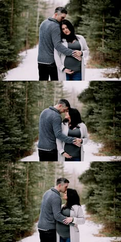 a man and woman hugging each other in the snow with pine trees behind them on either side