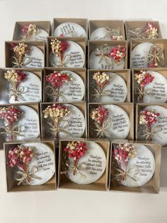 twelve wedding favors in boxes with red and white flowers on the inside one is for each guest