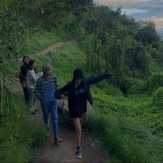 several people walking up a steep hill on a trail