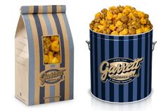 two bags of popcorn sitting next to each other on a white surface with blue stripes