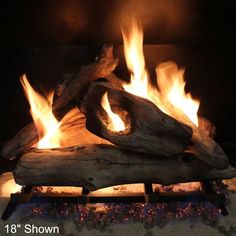 a fire burning in a fireplace with logs