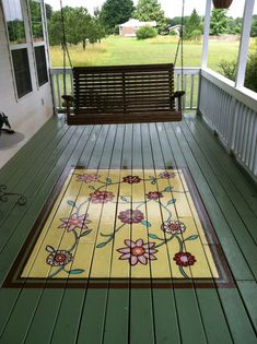 a porch with a bench and rug on it