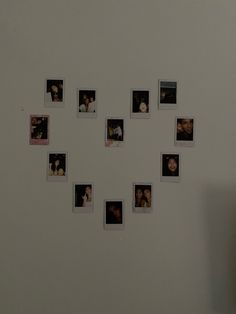 a white wall with many pictures arranged in the shape of a clock on it's side