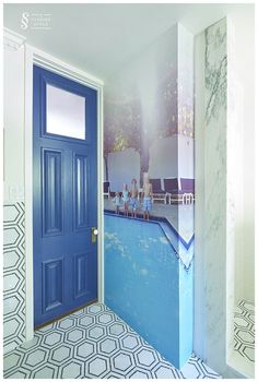 a blue door is in front of a wall mural