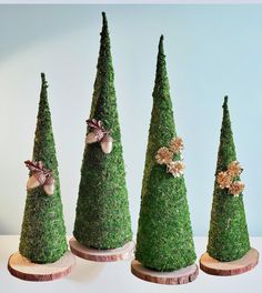 three small green trees with bows on them