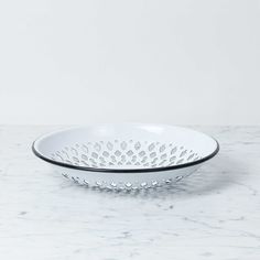 a white bowl sitting on top of a marble counter