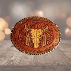 This hand-tooled leather western buckle combines rugged charm with artistic flair.  Crafted with attention to detail, hand-tooling adds depth and texture to the leather, creating a visually striking piece that is sure to turn heads. Made from high-quality leather mounted on a metal base with antique silver finish. The natural characteristics of the leather will develop a unique patina over time, making each buckle a truly personalized and cherished accessory. Hand Tooled Leather Belt Buckles For Ranch, Southwestern Hand Tooled Leather Belt Buckles, Western Leather Embossed Belt Buckles, Rustic Leather Belt Buckles For Rodeo, Traditional Hand Tooled Leather Belt Buckles, Leather Concho Belt Buckles For Rodeo, Western Leather Belt Buckles For Rodeo, Rustic Leather Belt Buckles For Ranch, Hand Tooled Leather Belt Buckles For Rodeo