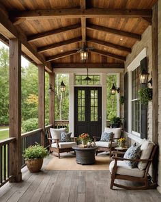 a porch with chairs and tables on the front porch, covered in wood planks