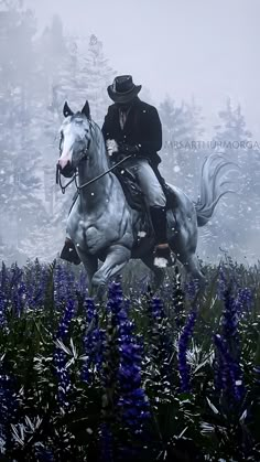 a man riding on the back of a white horse through a field of blue flowers