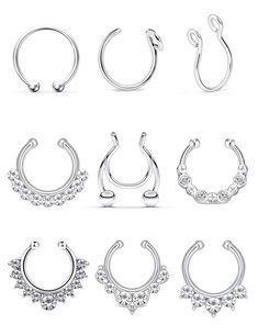 six pairs of silver nose rings with crystal stones on each side and an open circle