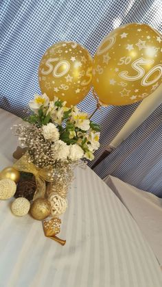 two balloons and some flowers on a table