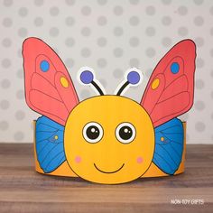 a paper butterfly sitting on top of a wooden table