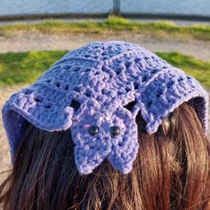 a close up of a person wearing a crocheted hat with an elephant's head