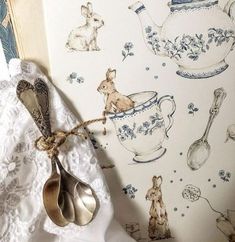 spoons and utensils are sitting next to a wallpaper with bunny images on it