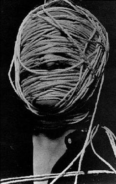 a woman with her head covered in rope