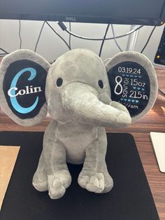 an elephant stuffed animal sitting on top of a desk