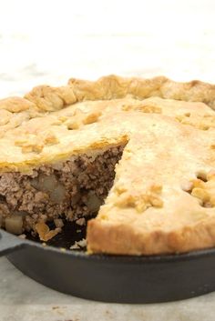 a pie sitting on top of a pan with a slice missing from it's crust