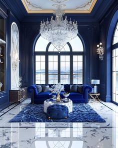 a living room with blue couches, chandelier and large windows in it