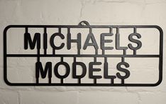 a metal sign that says michael's models on it