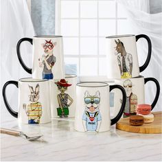 four coffee mugs with cartoon characters on them