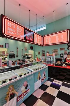 the inside of a fast food restaurant with neon signs hanging from the ceiling and checkered floor