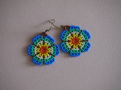 Huichol style seed bead flower earrings! cornflower blue and seafoam green beaded floral earrings. handmade beaded dangle earrings. Blue Flower Earrings With Colorful Beads, Blue Flower-shaped Beaded Earrings, Blue Flower Shaped Beaded Earrings, Blue Beaded Bohemian Flower Earrings, Blue Flower-shaped Earrings With Colorful Beads, Blue Flower Beaded Earrings, Bohemian Blue Flower Earrings With Colorful Beads, Blue Bohemian Flower Earrings With Colorful Beads, Seed Bead Flower Earrings