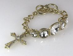 This is an incredible Christian Cross bracelet that features a stunning Cross charm with sparkling CZ stones throughout. The link chain have 2 size rings and 5 huge incredible CZ Stones. Very good quality! Comes in a beautiful satin lined gift box with a satin ribbon and bow, no wrapping required. We have large quantities available for bulk purchasing, please Ebay message us if you need a quantity larger than what is shown on hand. Rhinestone Fashion, Cuff Watch, Christian Cross, Cross Bracelet, Cross Charms, Satin Ribbon, Cz Stone, Bracelets And Charms, Fashion Watches