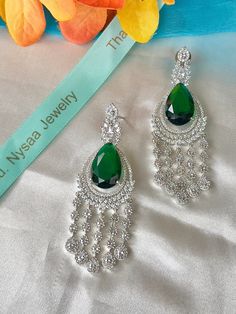 Beautiful high quality rhodium plated earrings, perfect for that elegant and classy look . The green emerald colored stone adds the perfections ! Wear it with any color . Get the matching ring from rings section . Must have for this wedding season . Pair up with the cocktail ring 💕 Green Diamond Chandelier Drop Earrings, Green Diamond Dangle Earrings For Formal Occasions, Green Dangle Diamond Earrings For Formal Occasions, Luxury Green Bridal Earrings For Party, Green Cubic Zirconia Chandelier Earrings For Formal Occasions, Green Diamond Earrings For Parties, Green Diamond Drop Earrings For Bridal, Green Cubic Zirconia Crystal Earrings For Party, Green Diamond Drop Bridal Earrings