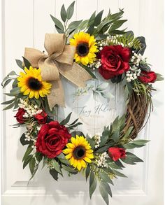 a wreath with sunflowers and red roses